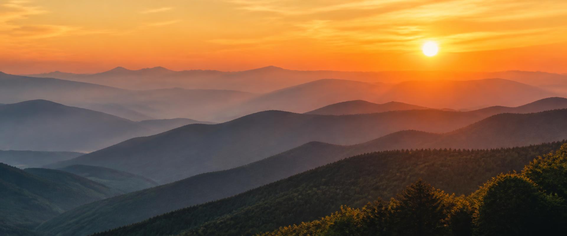 Layered mountain ridges glowing at sunset